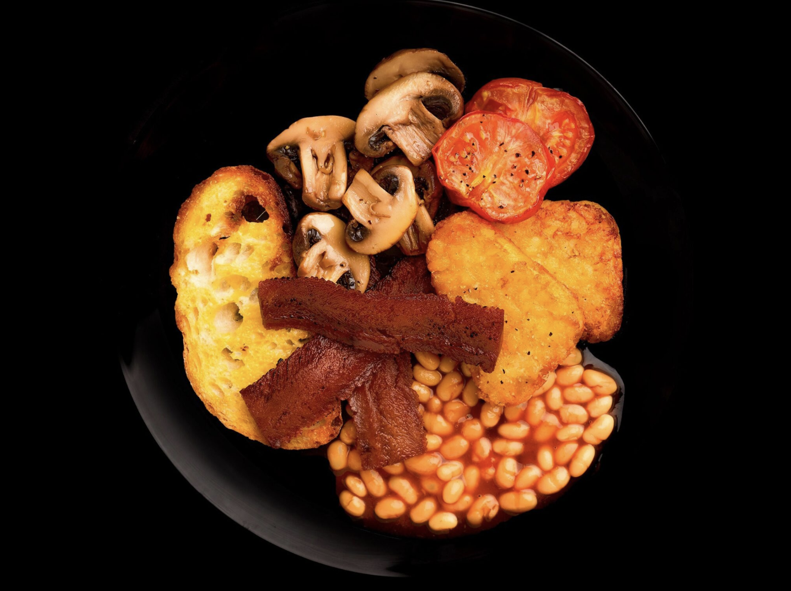 a plate of vegetables, bread, and alt-protein meats